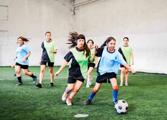 Meninas jogando futebol society.