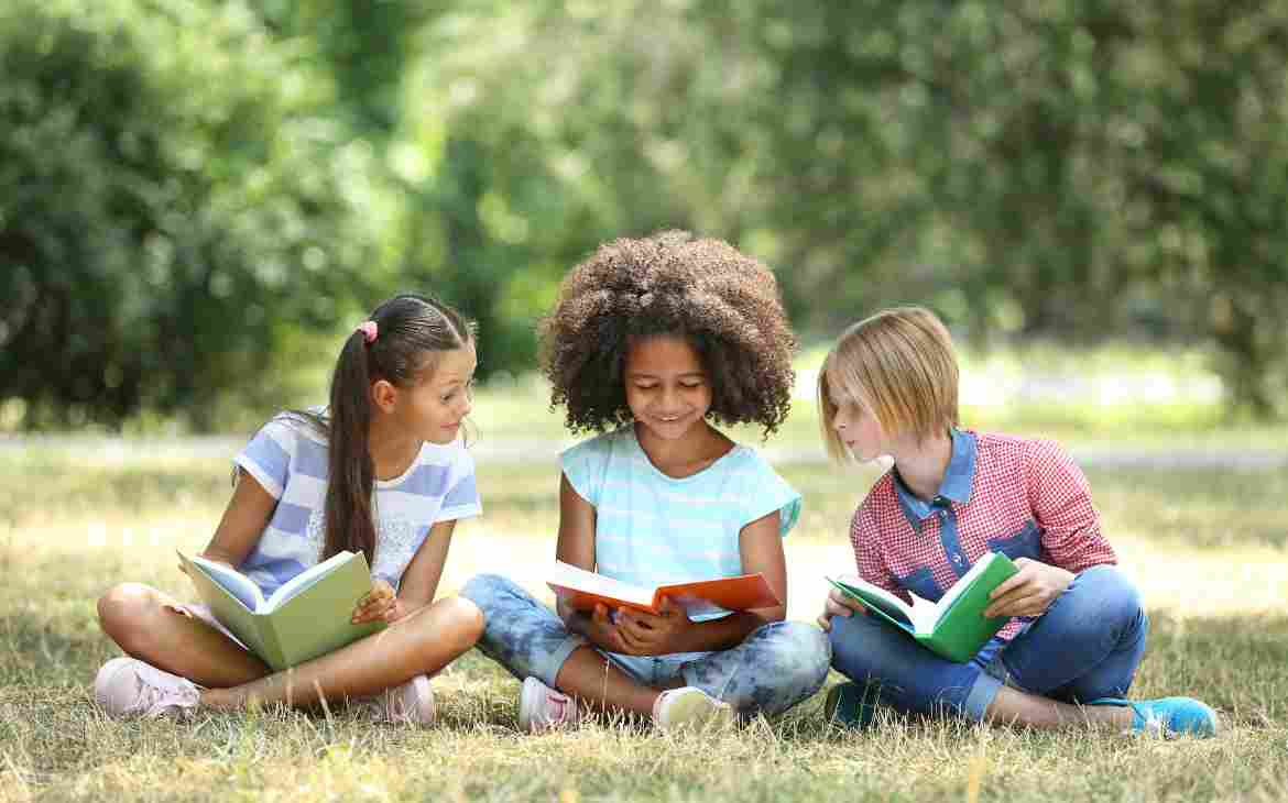 8 livros para falar sobre autoestima desde a infância. Três crianças lendo juntas